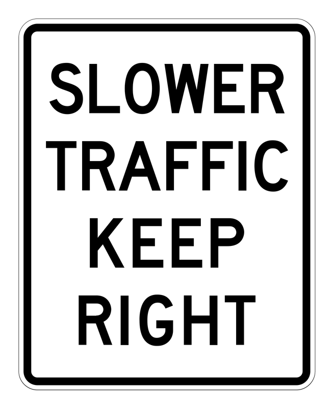 Slower Traffic Keep Right Sign road sign — White vertical rectangle reading SLOWER TRAFFIC KEEP RIGHT