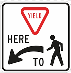 Yield Here to Pedestrian Sign road sign — Sign showing yield triangle, HERE TO text, arrow, and pedestrian